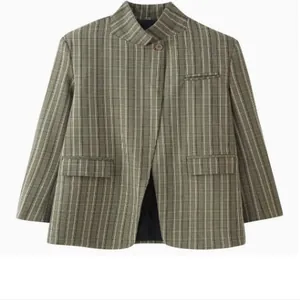 Close-up detail view of a vintage green plaid blazer with a mandarin collar and top button.