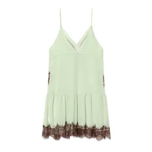 Elegant mint green slip dress featuring intricate brown lace trim at hem and sides