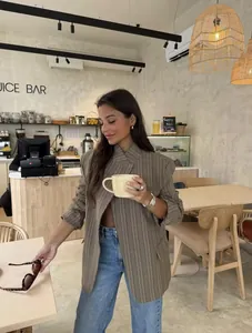 Stylish brown plaid blazer for women with a stand collar shown in a chic cafe setting