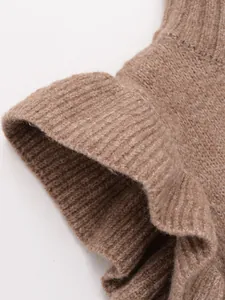Close-up showing the soft brown ribbed knit texture of a fashionable layered vest