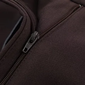 Close-up view of durable metal zipper detail on brown casual women's shorts.