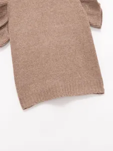 Close-up detail of a brown knitted vest featuring elegant ruffle shoulder accents
