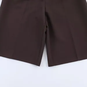 Detailed close-up of brown casual shorts highlighting the leg hem and fabric quality