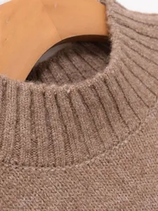 Close-up detail of ribbed neckline and brown knit texture of a fashionable vest