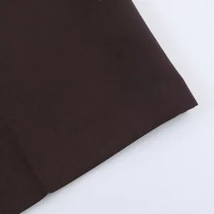 Close-up detail of the dark brown high-quality woven fabric for women's fashion shorts