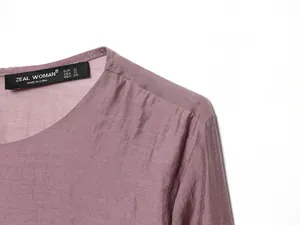 Dettaglio di un top casual viola che mostra l'etichetta e la trama del tessuto