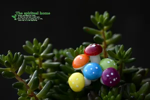 Macro detail of colorful mini foam mushroom ornaments nestled in green succulent plants