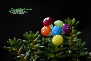 Detailed close-up of colorful mini foam mushrooms decorating a green succulent plant