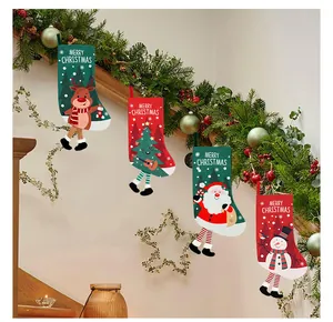 Set of four colorful Christmas stockings hanging on festive garland for home decoration