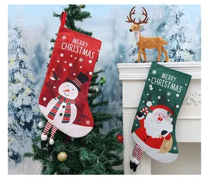 Pair of festive red and green Christmas stockings featuring snowman and Santa Claus designs