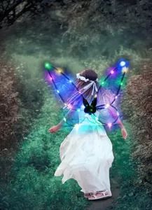Little girl wearing glowing purple LED fairy wings walking in a magical forest path.