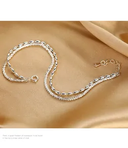 Detail view of a double-layer 925 silver bracelet featuring rice beads and starry chain.
