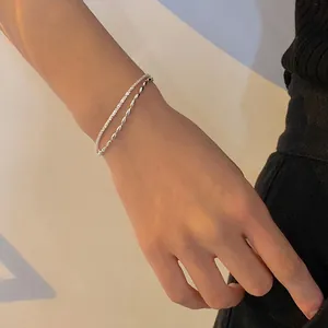 Close-up of double-layer silver-plated bracelet with rice grain and starry sky chains