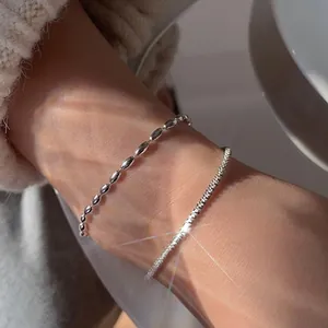 Detail shot of double-layered silver bracelet with rice beads and starry texture