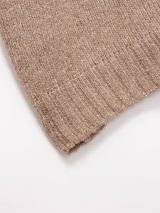 Macro view of soft brown knitted vest featuring high-quality ribbed hem detail