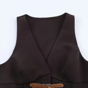 Detailed view of the V-neckline and decorative belt on a dark brown fashion vest top.