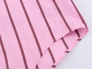 Close-up detail of the curved hem and fine stitching on a pink striped casual shirt.
