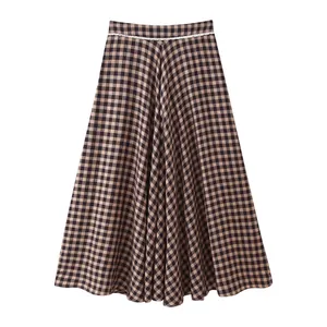 Close-up detail of a long brown and black gingham skirt featuring white lace waist.