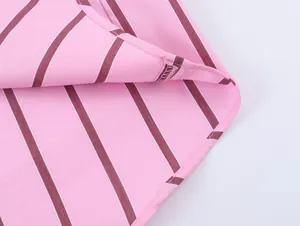 Close-up detail of pink and maroon striped shirt showing stitching and fabric texture.