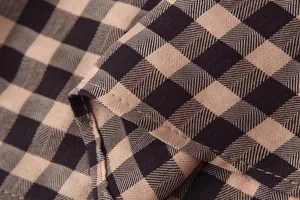 Close-up of black and tan gingham fabric detail with high-quality stitching