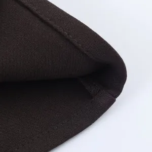Close-up detail of the fine knit fabric and stitching on this brown fashion skirt set.