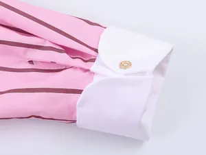 Close-up detail of a pink striped shirt with contrasting white button cuffs