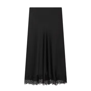 Detailed view of this black satin midi skirt with delicate lace trim at the hemline
