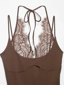 Close-up detail of the intricate floral lace and halter neckline tie on a brown bodysuit
