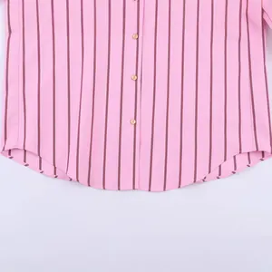 Detailed view of fashionable pink striped casual shirt featuring a curved hem and buttons