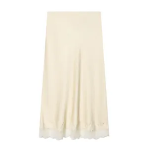 Detailed view of the elegant champagne satin midi skirt with delicate lace hem trim