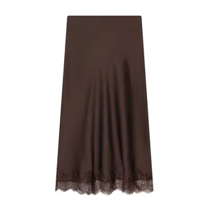 Detail view of brown satin midi skirt featuring elegant scalloped lace trim at hem