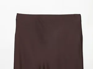Detailed close-up of dark brown satin silk texture midi skirt showing waistband detail