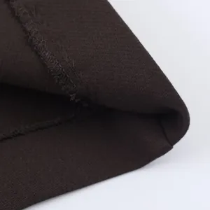 Close-up detail showing the fine stitching and texture of the dark brown fabric