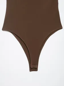 Detailed view of dark brown halter neck bodysuit featuring secure snap button closure