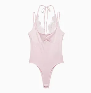 Detailed view of the pink lace halter bodysuit featuring a delicate eyelash lace trim