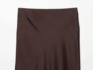 Close-up of brown satin midi skirt showing high waist and smooth silk-like texture