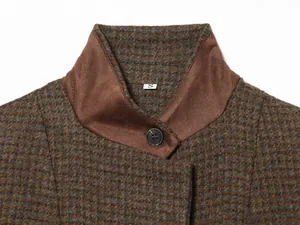 Close-up detail of plaid patchwork stand collar blazer with button and size tag