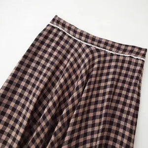 Classic brown and black checkered skirt featuring elegant white lace trim at the waistline