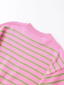Detailed view of pink and green horizontal striped round neck sweater collar texture