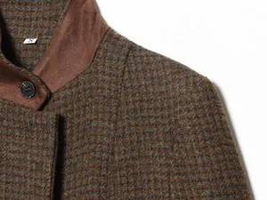 Detailed view of women's plaid splicing stand-collar blazer showing fine fabric texture