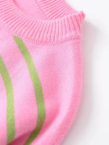 Macro view showing the ribbed neckline and texture of pink and green striped knit sweater