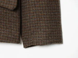 Detailed macro view of the checkered wool blend fabric on a casual stand collar blazer