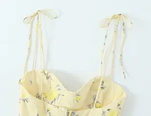 Vista detallada de camisola con estampado floral amarillo y tirantes ajustables