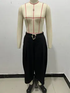 Fashionable black high-waisted wide-leg trousers featuring a unique gold buckle accent