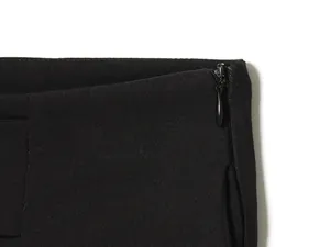 Detailed macro shot showing an invisible side zipper on high-quality black casual trousers