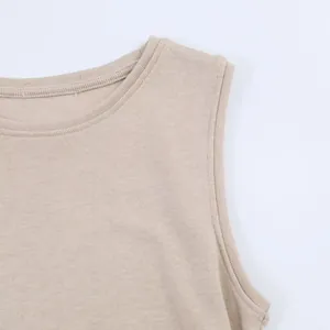 Close-up of the ribbed neckline and soft knit fabric of a beige sleeveless top.