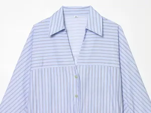 Detail view of a blue and white striped shirt featuring a V-neckline and collar