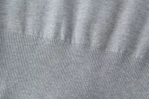 Close-up detail of gray knitted fabric texture for women's cardigan and shorts set