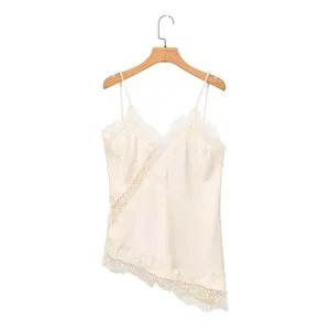 Detailed view of cream satin camisole with delicate lace trim and asymmetric hem