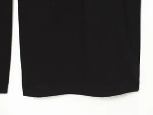 Macro view of the hem stitching on these stylish casual black wide-leg bucket pants.